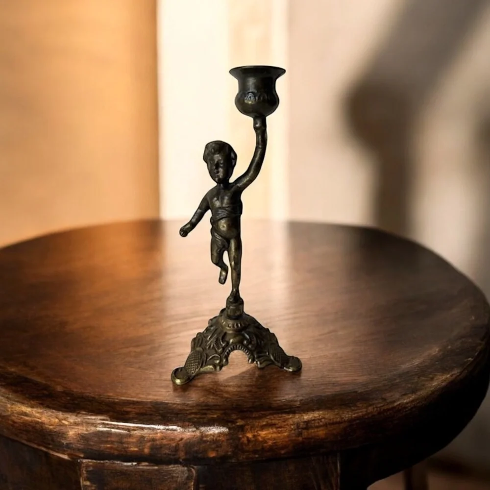 Antique cherub figurine candle holder